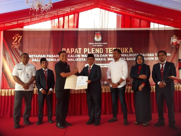 Ketua KPU Baubau Supardi saat menyerahkan salinan Berita acara rapat pleno penetapan pasangan calon Walikota dan wakil walikota terpilih pada Pilkada 2024 ke Pimpinan DPRD Kota Baubau Natas Aryu Prawira Tamim SM., MM